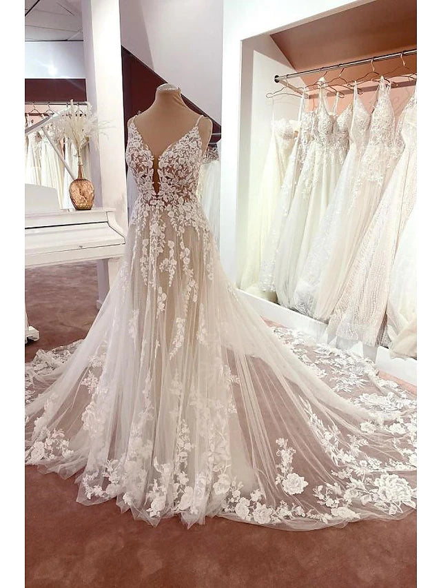 Elegant A-line V-neck lace wedding dress with spaghetti straps, front view.