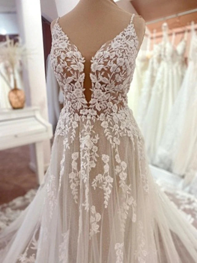 Side view of a romantic A-line wedding gown with intricate lace details.
