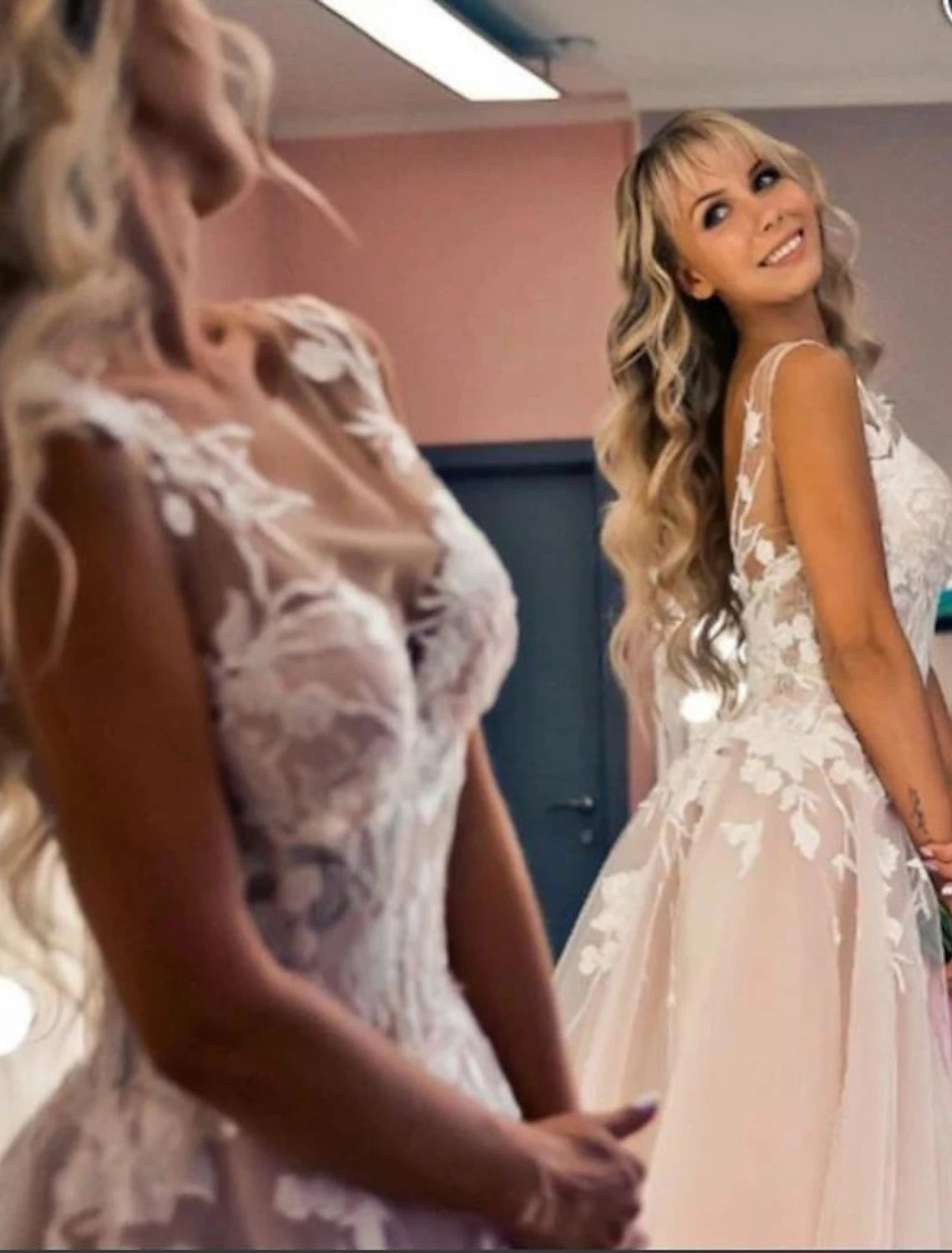 A-Line V-neck wedding dress with lace appliques and court train.