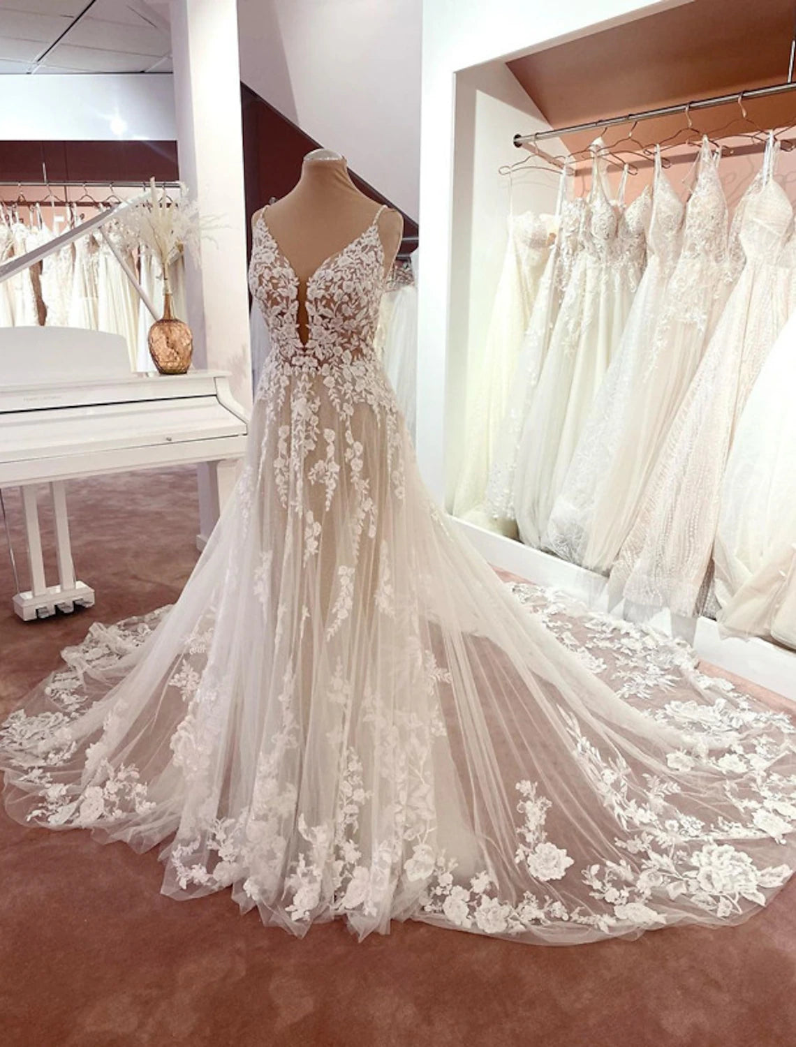 Elegant A-line wedding dress with V-neck and spaghetti straps.