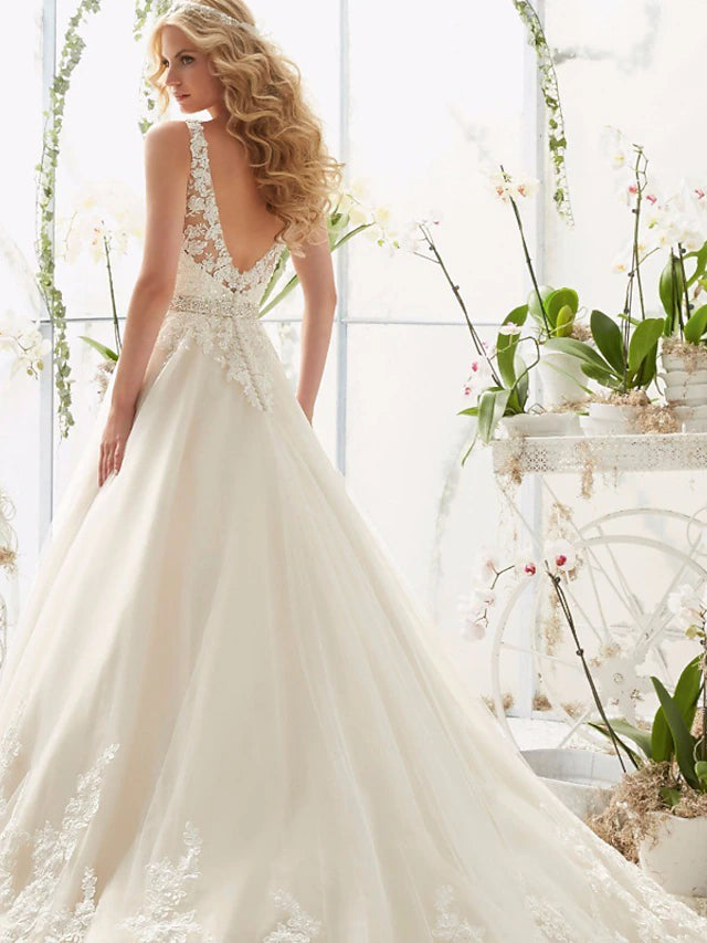 Back view of the A-line wedding dress, highlighting the open back and lace details.