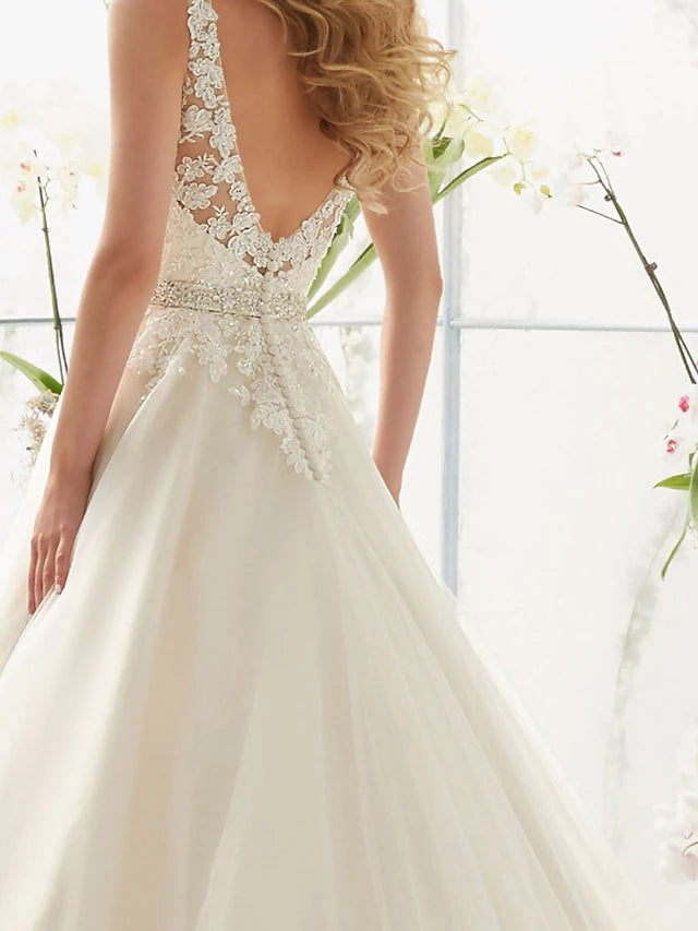 Close-up of the lace bodice and V-neckline of the wedding dress.