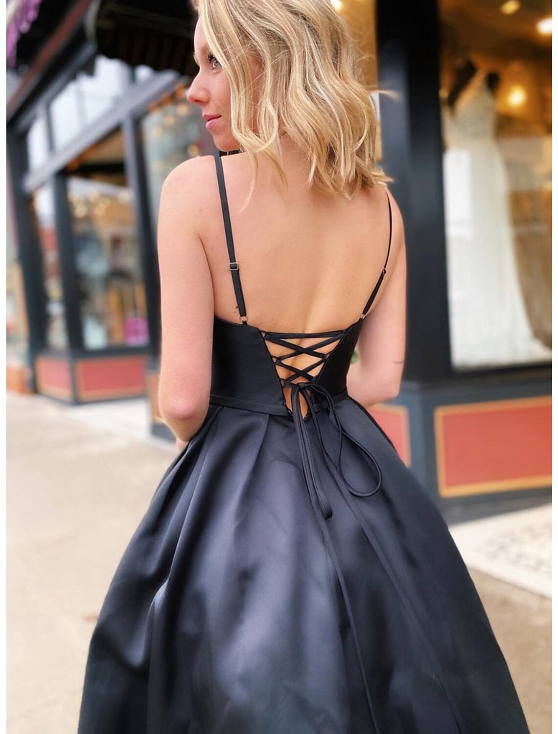 Close-up of the stretch satin A-line prom dress, showing the V-neck and pocket detail.