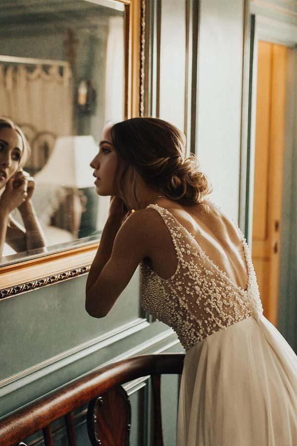 Side view of the flowing ivory A-line wedding gown.