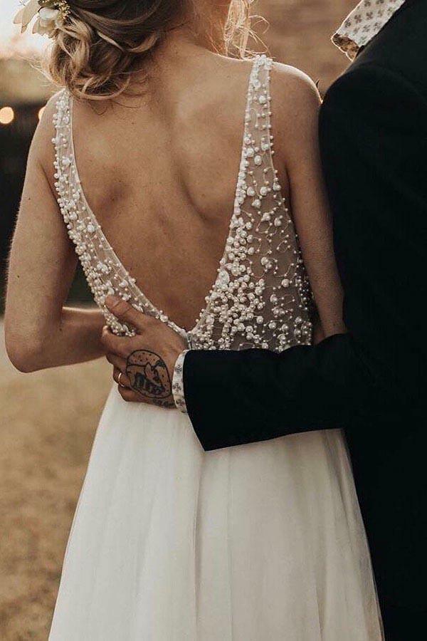 Full length view of the ivory see-through pearl beaded bridal dress.