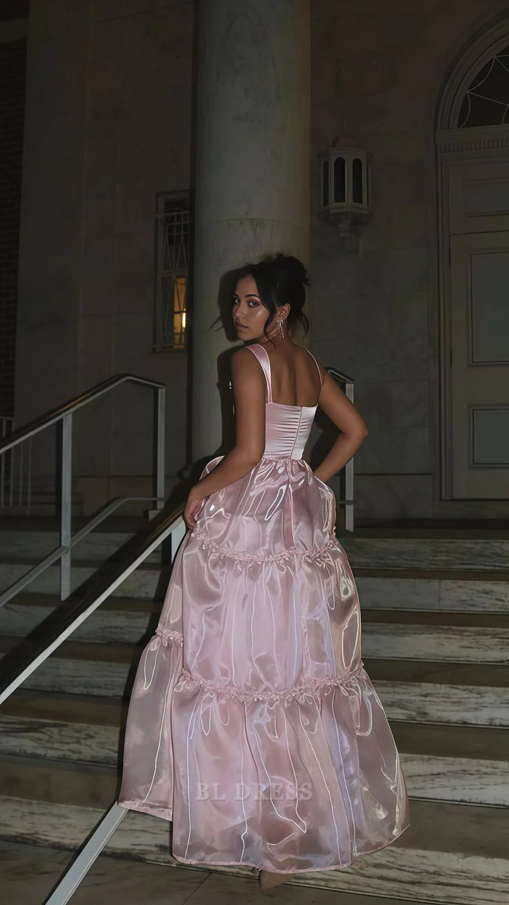 Full view of a pink organza floor-length prom dress.