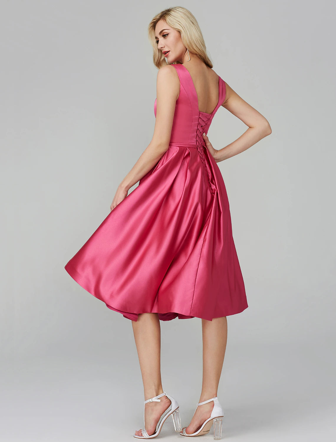 Back view of pink satin A-line dress with sash detail.