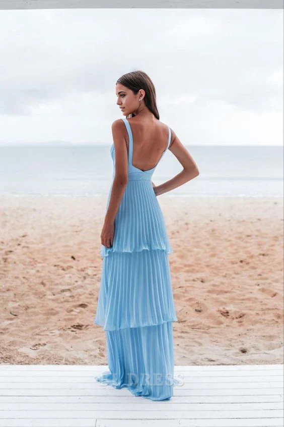 Back view of a blue A-line pleated formal dress, showcasing the backless design.