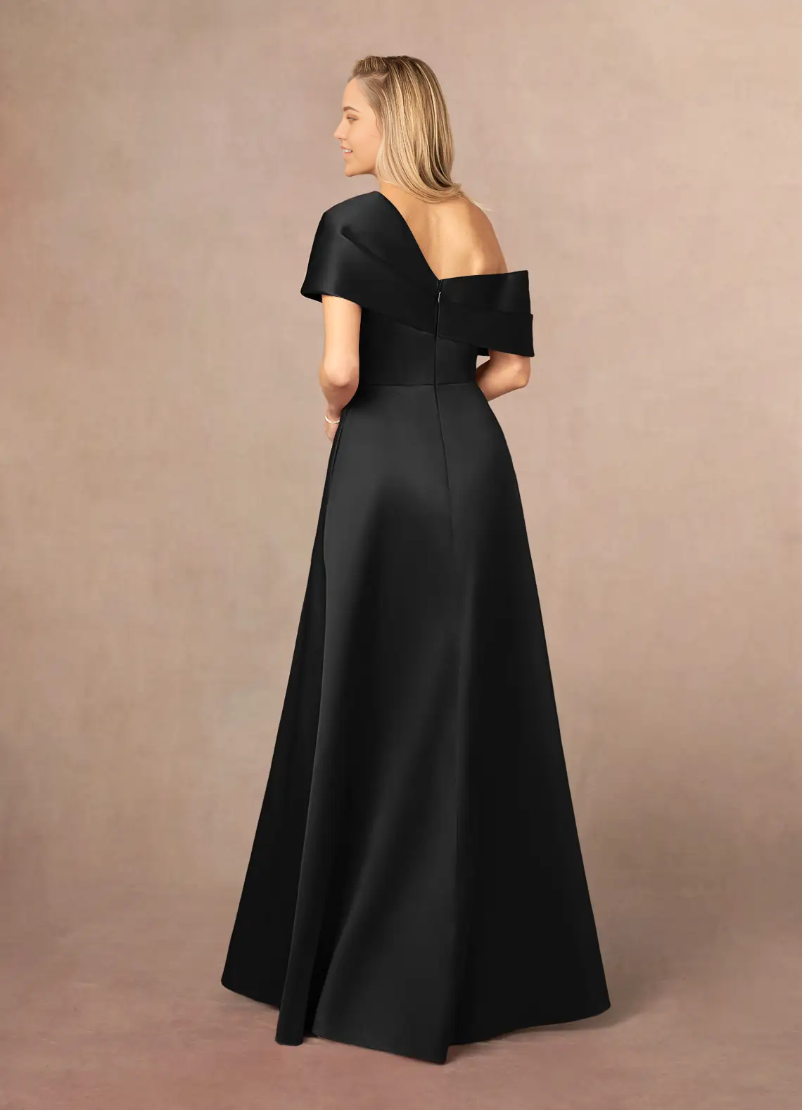Woman wearing an elegant black A-line V-neck pleated formal dress, side view.