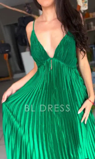 Back view of a green V-neck formal dress, showing the delicate spaghetti straps and elegant drape.