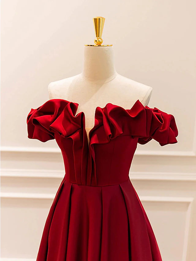 Side view of the flowing floor-length evening dress, highlighting the A-line silhouette.