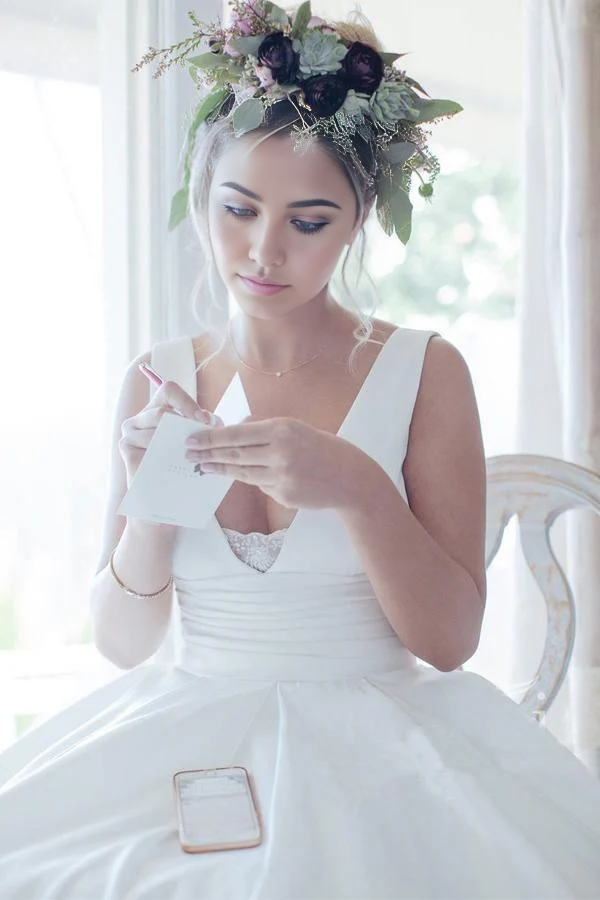 Back view of the simple V-neck satin wedding dress.