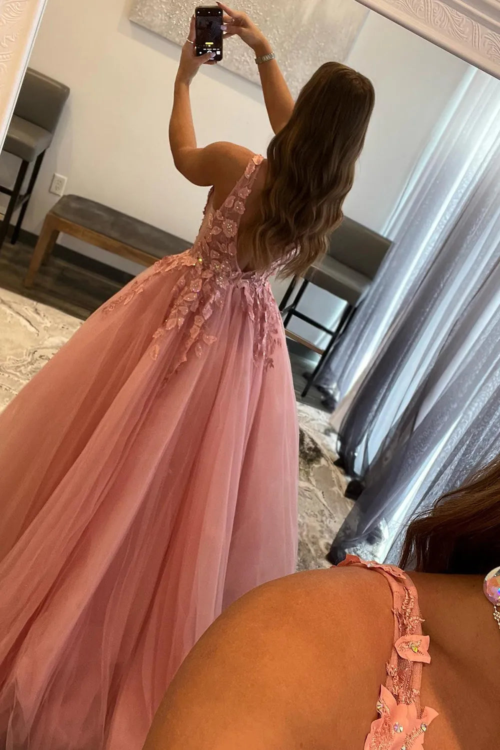 Close-up of the V-neck bodice and intricate appliques on a lavender prom dress.