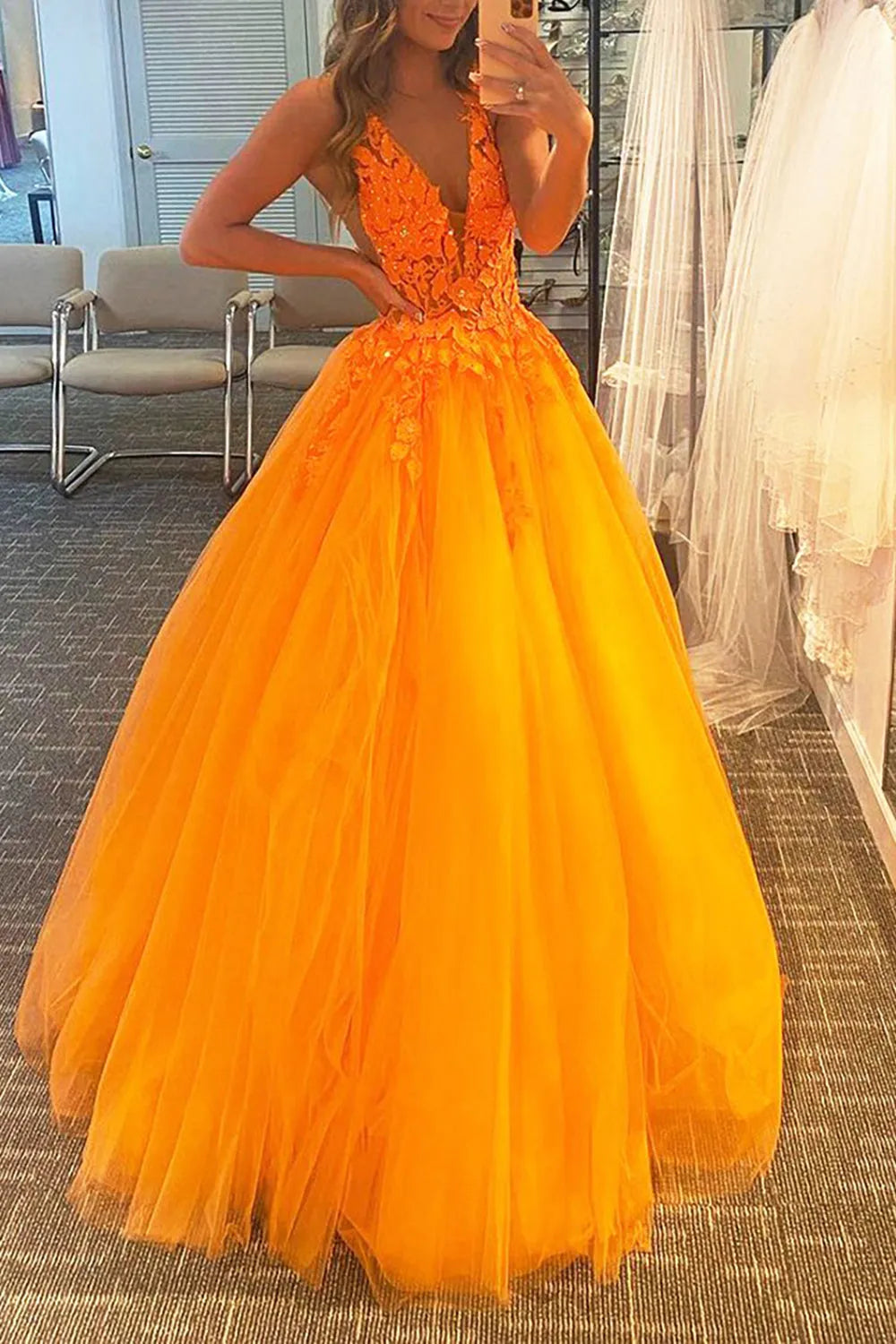 Model gracefully posing in a lavender A-line prom dress with appliques.