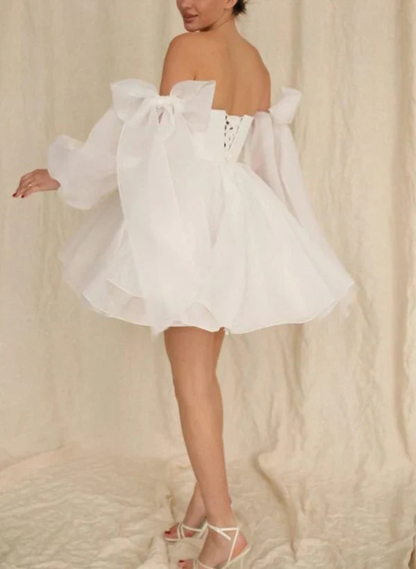Side view of the A-Line wedding dress, showcasing puff long sleeves and flowing skirt.