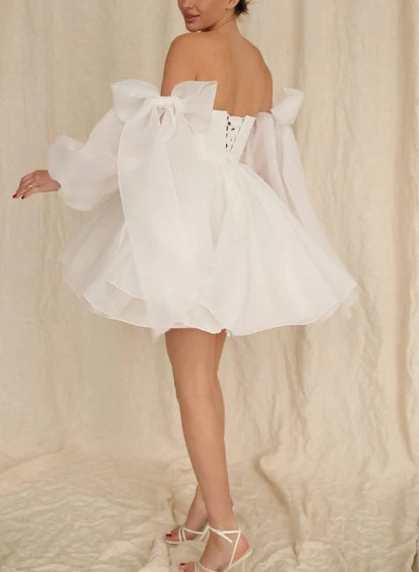 Side view of A-Line short wedding dress showing puff long sleeves and bow detail.