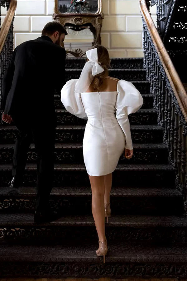 Back view of a bride wearing the ivory short wedding dress with puff sleeves.