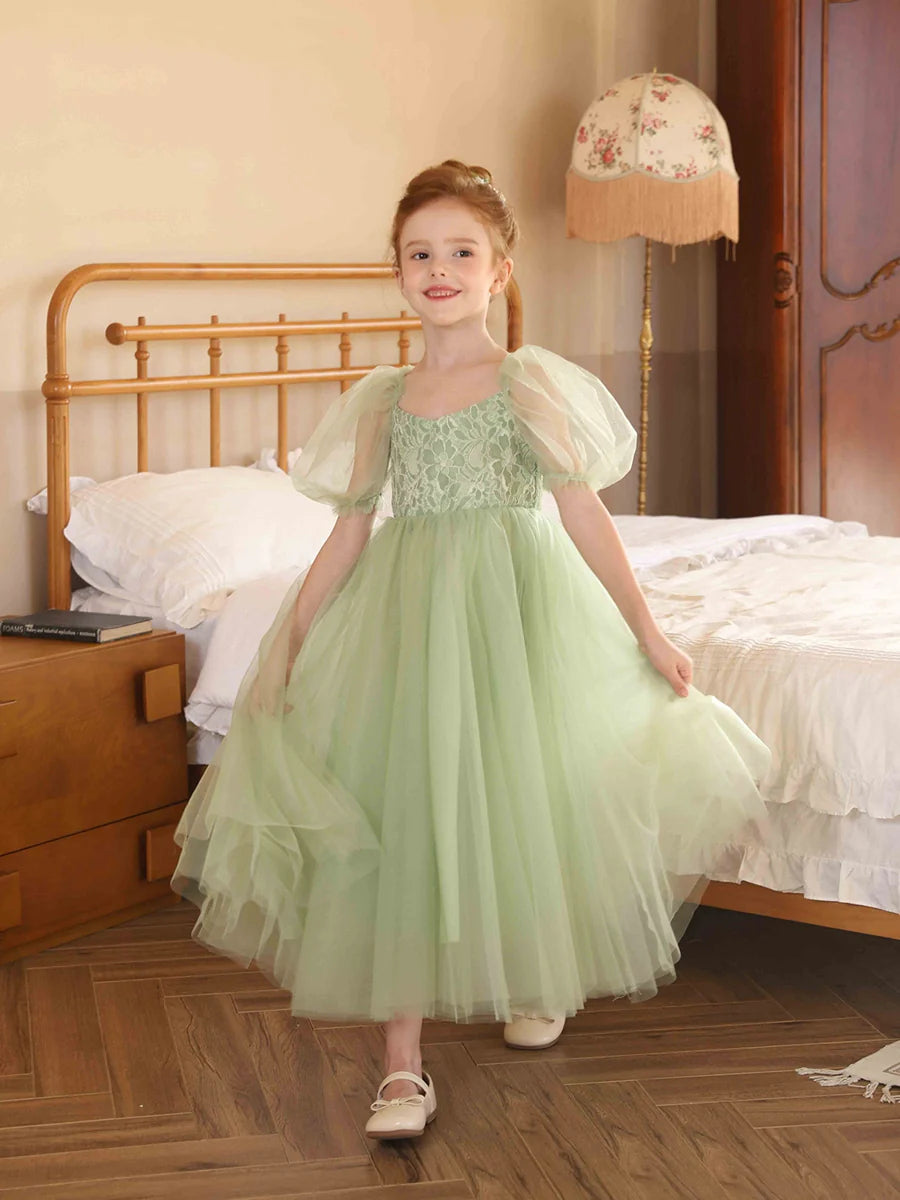 Full view of an elegant A-line tulle flower girl dress with V-neck and puff sleeves.