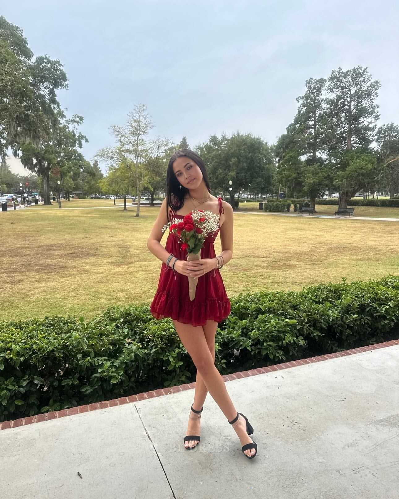 Red satin A-line short dress with spaghetti straps and V-neck, suitable for formal events.