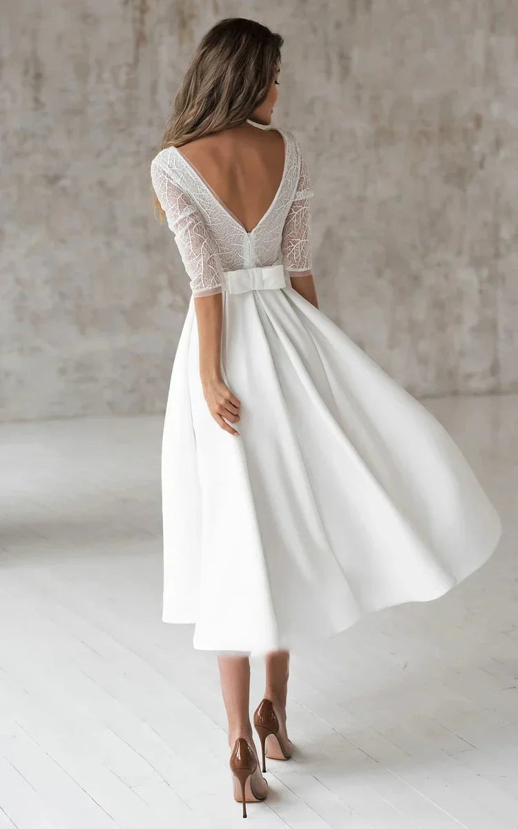 Margaritte A-Line V-neck satin tea-length wedding dress with ruching and sash.