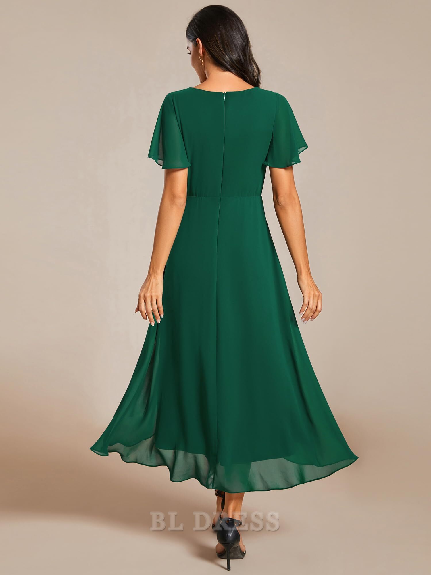 Woman wearing a pleated A-Line V-Neck high-low bridesmaid dress.
