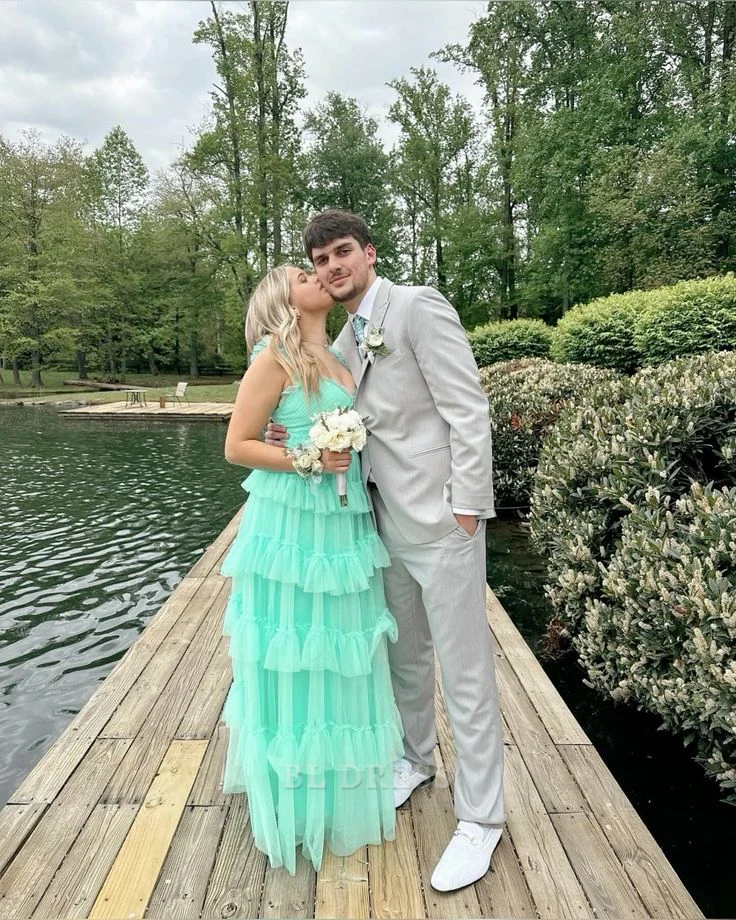 Elegant green A-line formal dress with V-neckline and delicate ruffles, suitable for bridesmaids or prom.