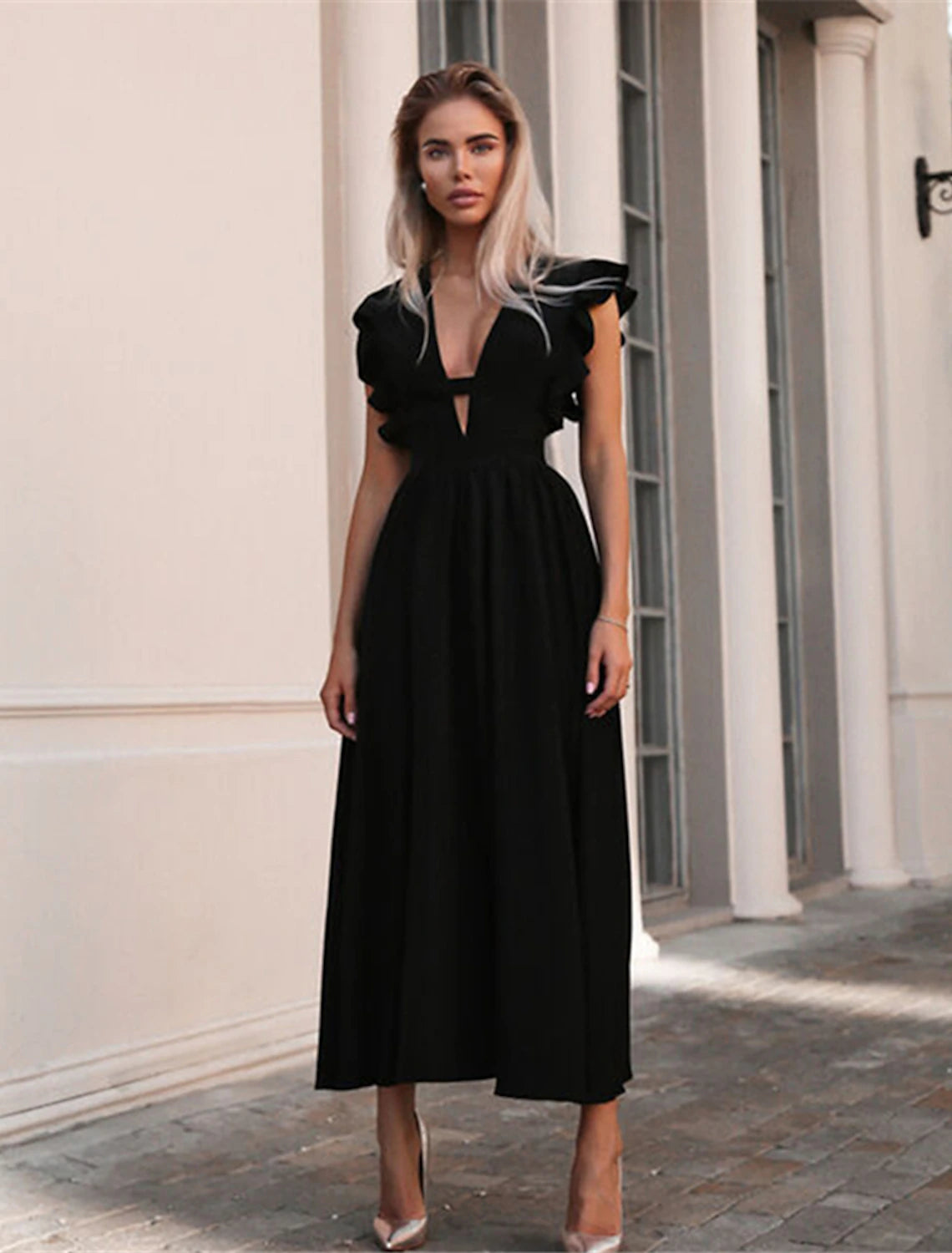 Detail of the V-neckline and ruffles on the dress.