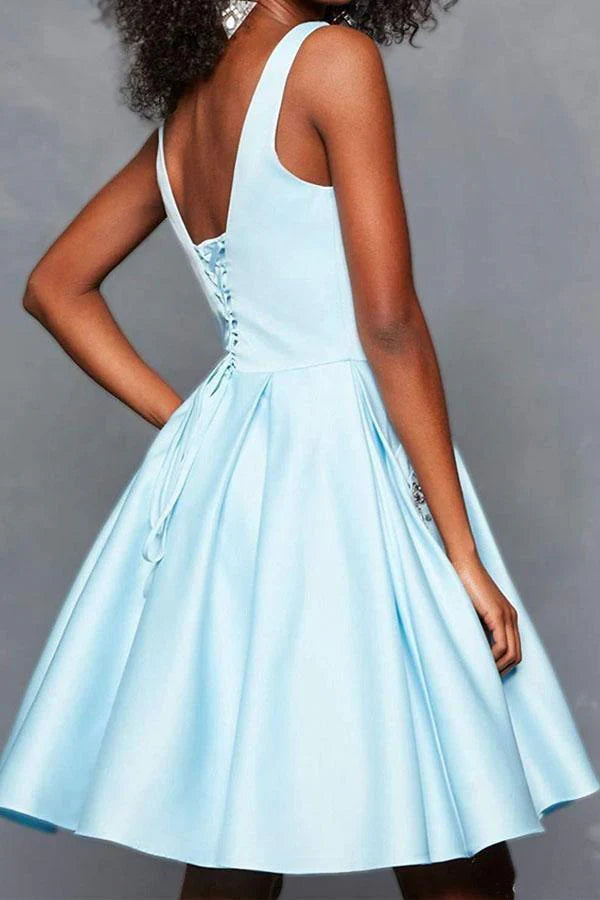 Detail of the V-neckline and beading on the satin homecoming dress.