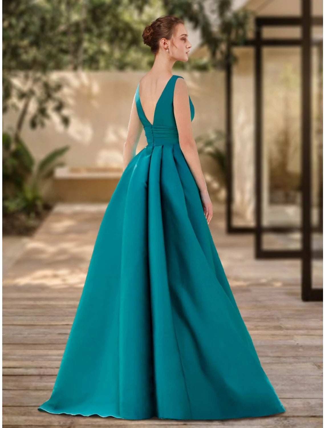 Model wearing a green A-line V-neck satin evening gown with ruched details and a sweep train.