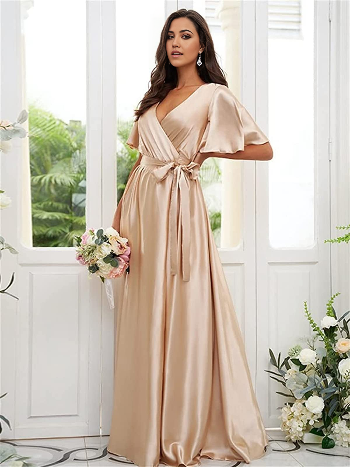 Woman wearing an elegant A-line V-neck satin gown with a high slit.
