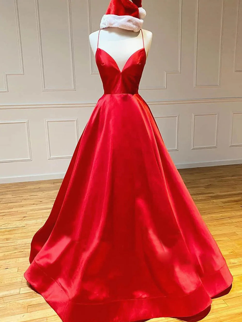Woman wearing an elegant A-line V-neck satin long prom dress, front view.
