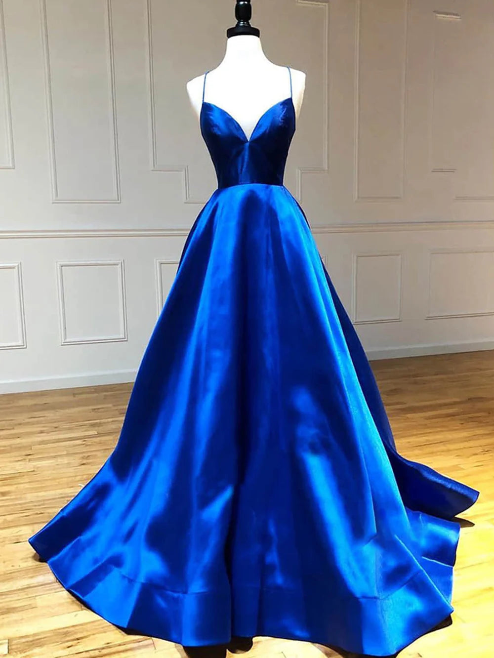 Back view of a woman showcasing the A-line V-neck satin long prom dress.