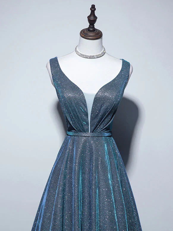Close-up of V-neckline and satin fabric on a long prom dress.