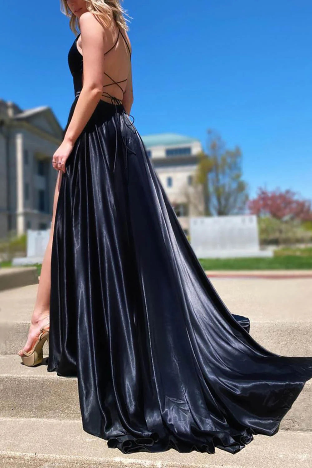 Back view of an A-line V-neck satin long prom dress, showcasing the flowing fabric and design.