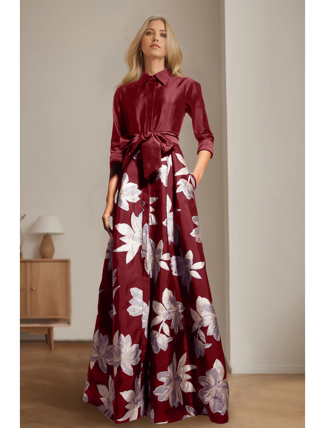 Floor-length A-line satin gown featuring a sash detail and 3/4 sleeves.