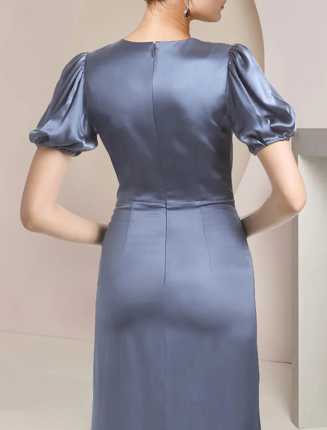 Close-up of the cascading ruffles and satin fabric on the elegant Mother of the Bride dress.