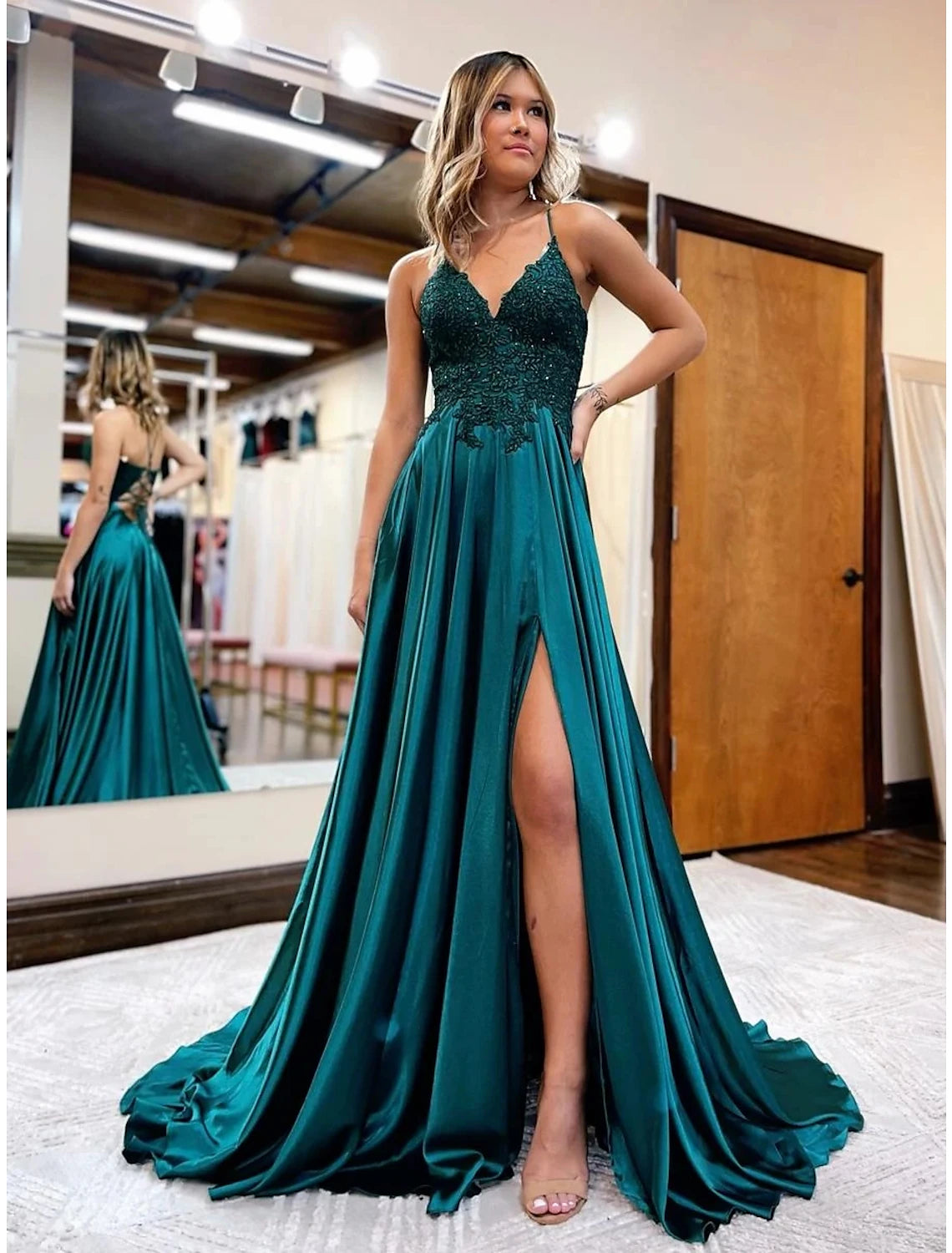 Back view of a sleeveless satin gown featuring a court train.