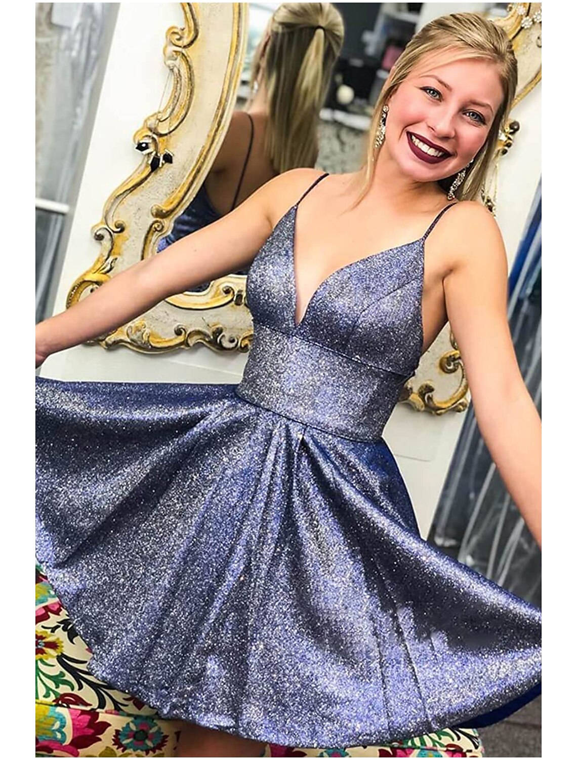 Front view of a model wearing a short A-line satin V-neck cocktail dress.