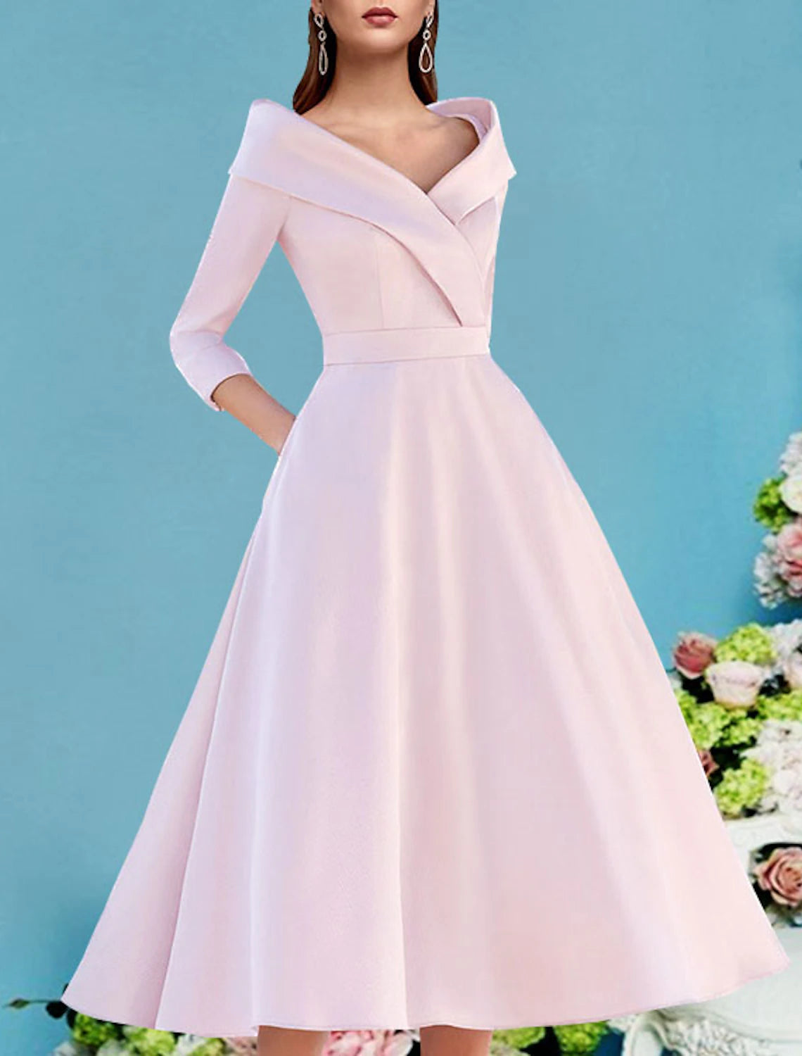 Close-up of the pleated detail on the satin dress.