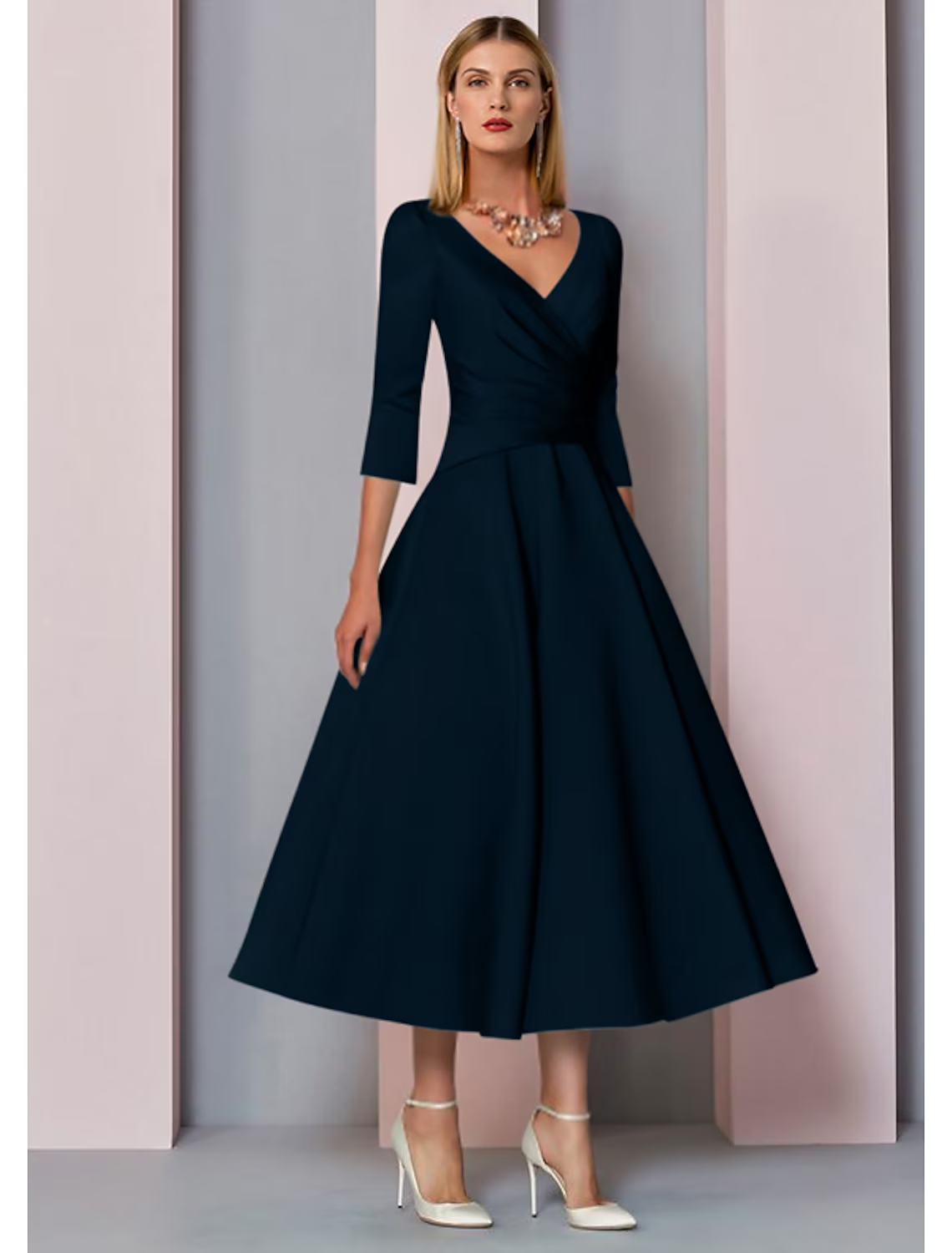 Side view of the vintage-inspired tea length dress, showing pleats.