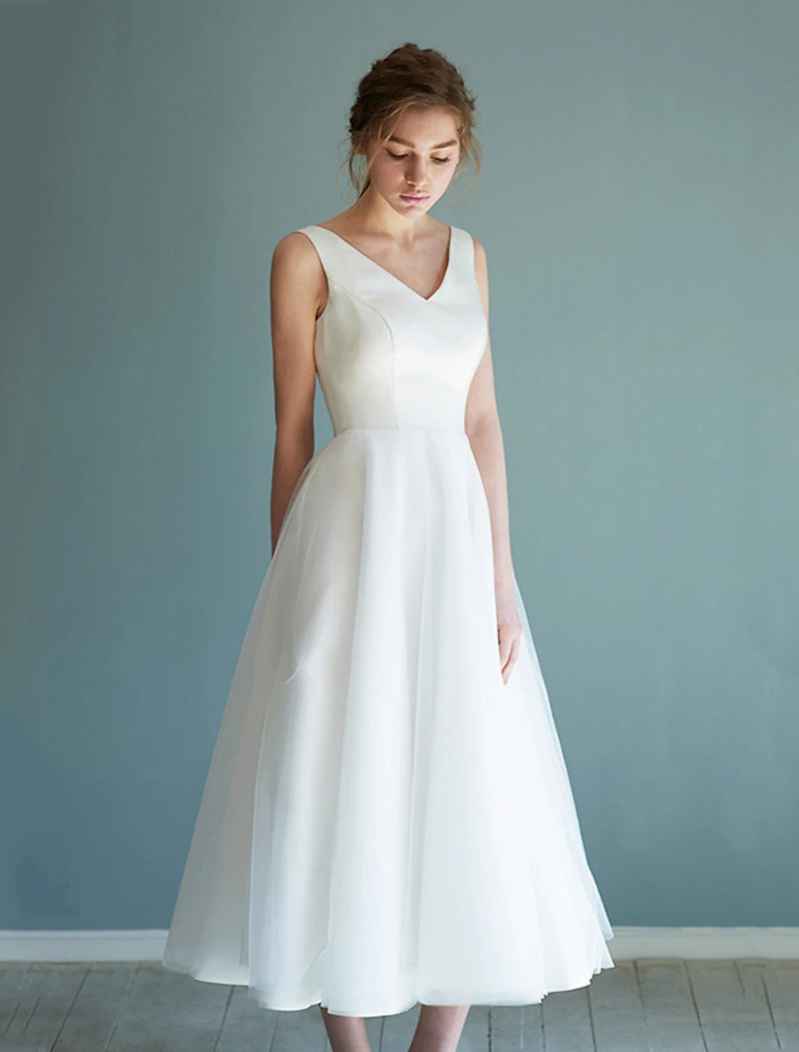 Elegant white A-line V-neck satin tea length wedding dress.