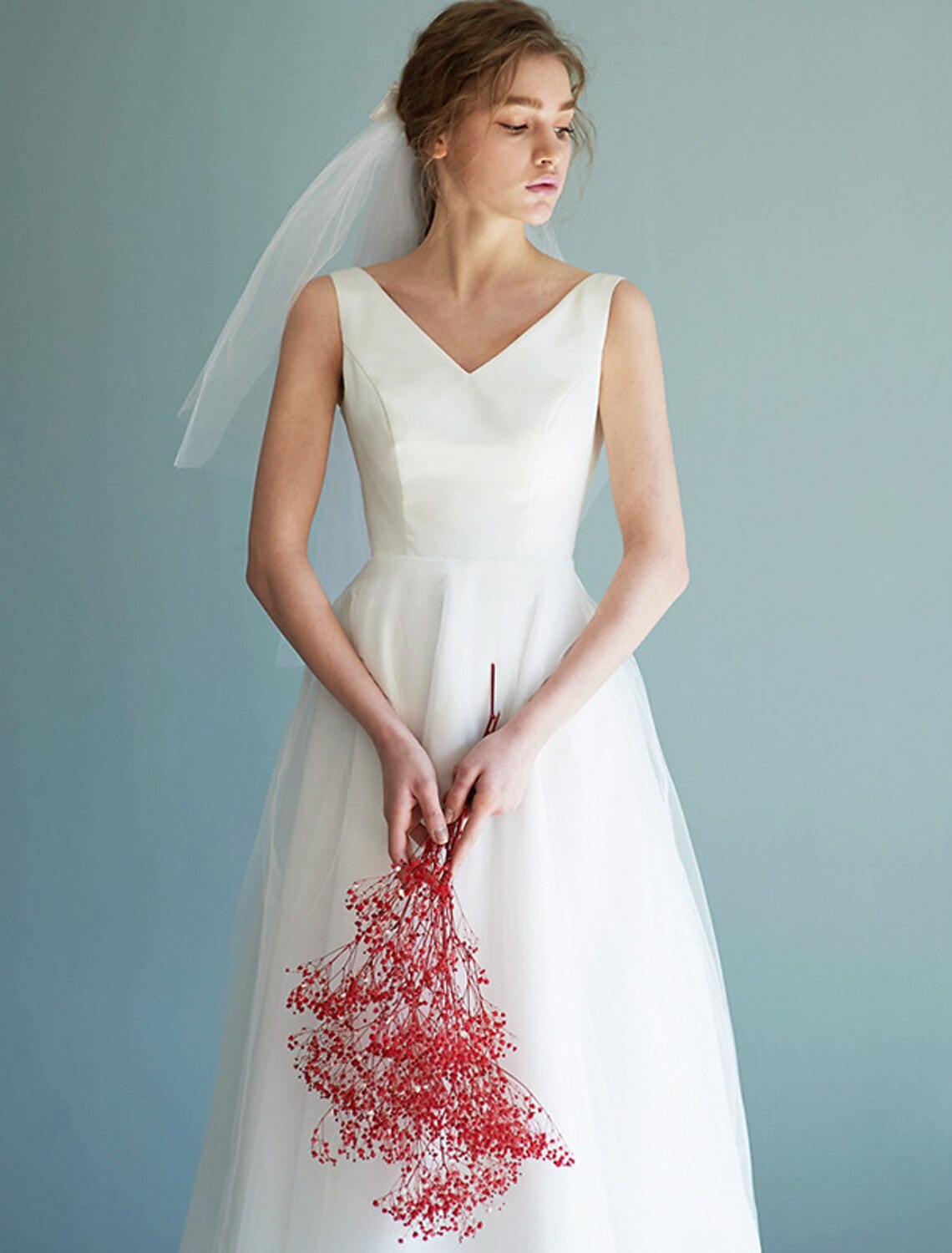 Back view of the white A-line V-neck satin tea length wedding dress.
