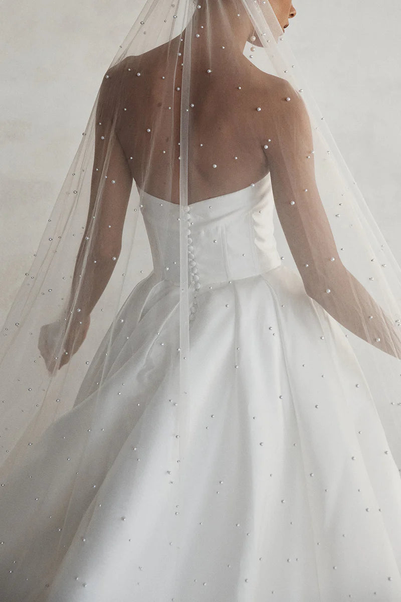 Satin wedding gown featuring an A-line silhouette and side slit.