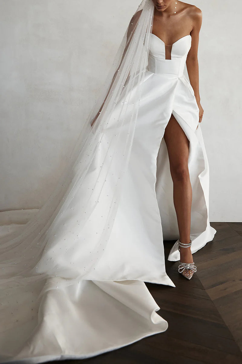 Full view of the simple A-line V-neck satin bridal gown.