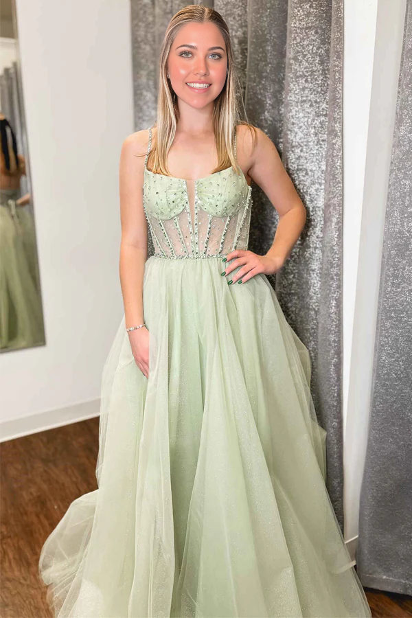 Model wearing an elegant A-line V-neck sage green sequin beaded tulle prom dress.