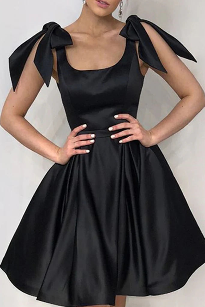 Woman wearing an elegant short A-line V-neck dress with bows on the straps, front view.