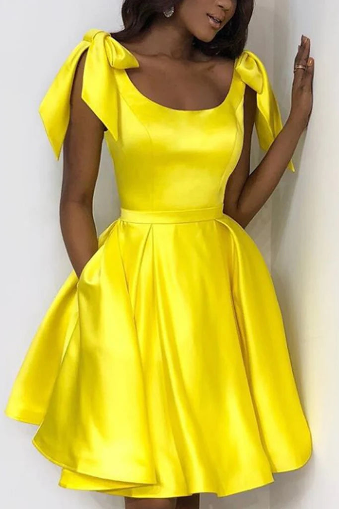 Side view of a woman in the short A-line V-neck dress with bow details.