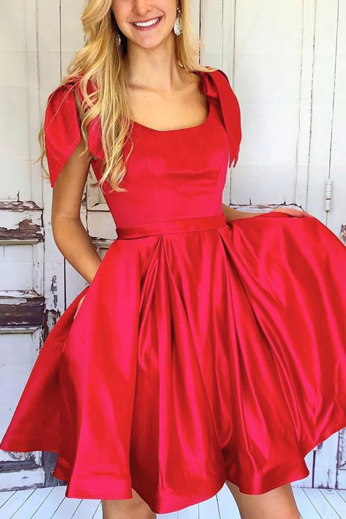 Back view of the short A-line V-neck dress with delicate straps and bows.