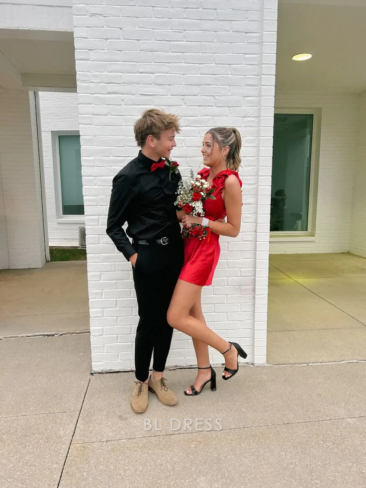 Woman wearing a short red A-line V-neck formal dress, suitable for prom or bridesmaids.