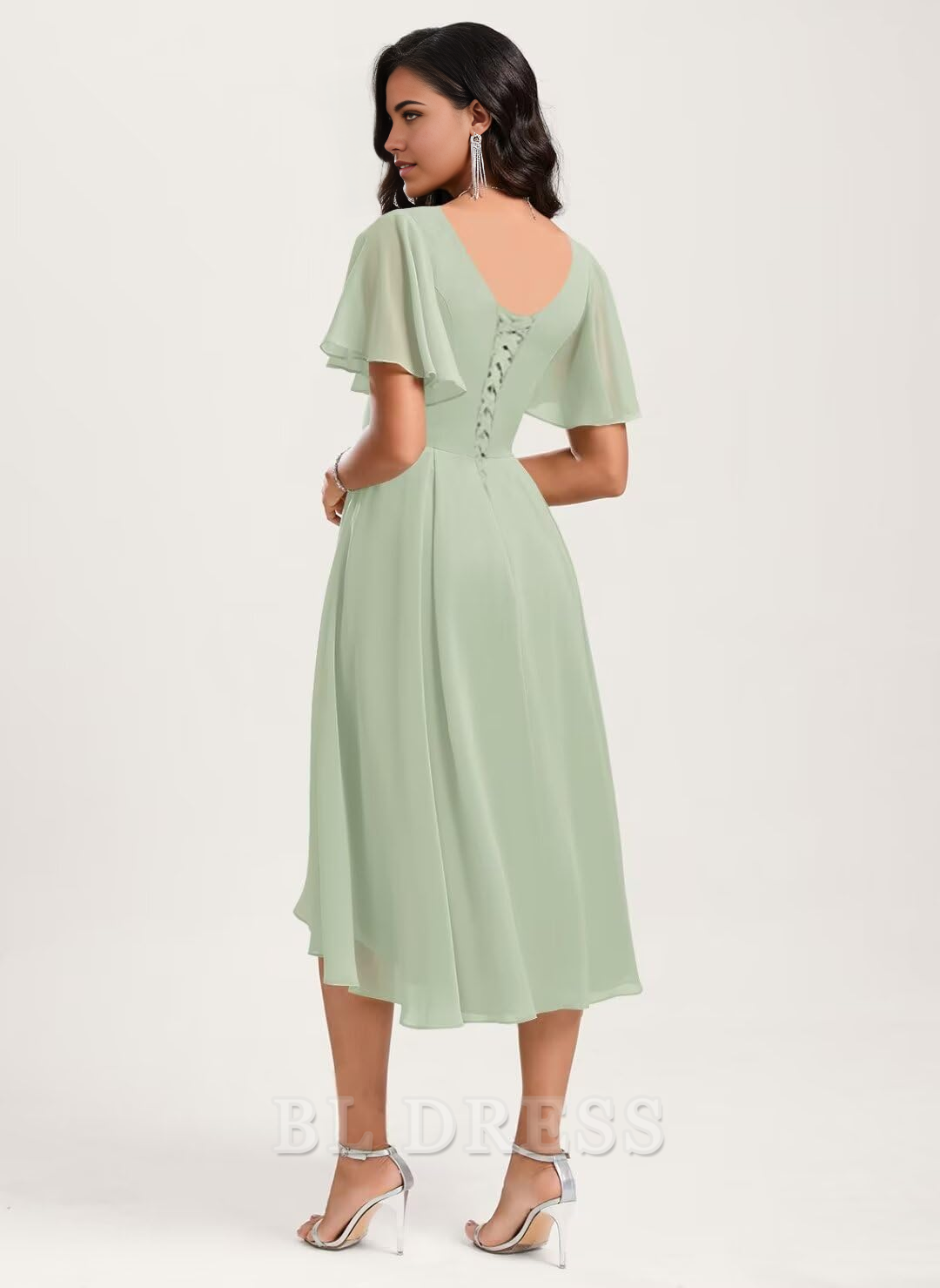 Back view of an A-line V-neck short sleeve chiffon dress, showcasing the flowing asymmetrical skirt.